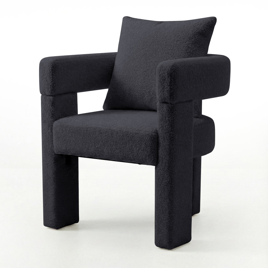 Utah Bouclé Curved 3 Legged Accent Chair in Black with plush bouclé upholstery, squared padded seat, thick tubular armrests
