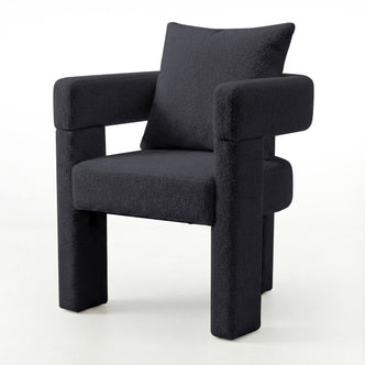 Utah Bouclé Curved 3 Legged Accent Chair in Black with plush bouclé upholstery, squared padded seat, thick tubular armrests