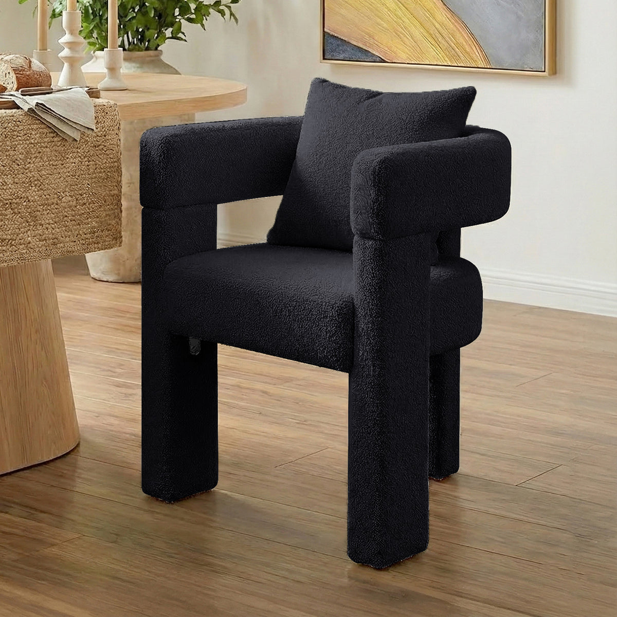 Utah Bouclé Curved 3 Legged Accent Chair in Black with plush textured upholstery, U-shaped backrest and thick cylindrical
