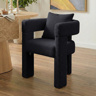 Utah Bouclé Curved 3 Legged Accent Chair in Black with plush textured upholstery, U-shaped backrest and thick cylindrical