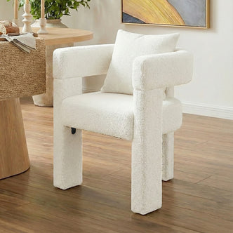 Utah Bouclé Curved 3 Legged Accent Chair in Cream with plush bouclé upholstery, chunky cylindrical legs and curved armrests