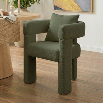 Utah Boucle Curved 3 Legged Accent Chair in Green, featuring chunky cylindrical legs, wide padded armrests, and a matching