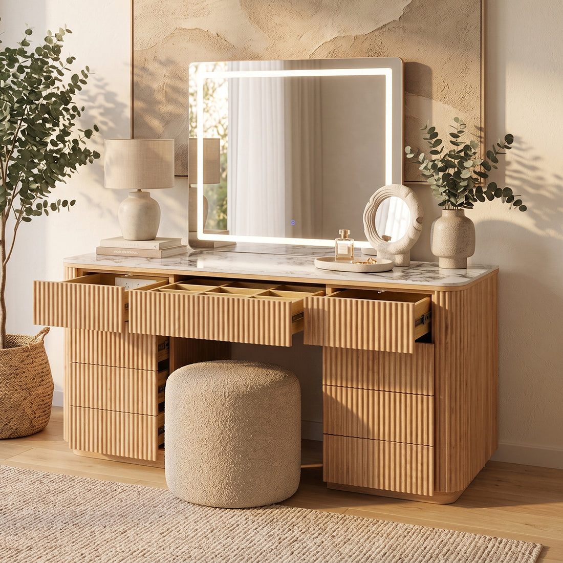 Natural fluted vanity with marble top, open drawers with dividers, LED mirror, and boucle stool in neutral bedroom setting