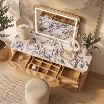 Natural wood vanity with marble-look top, open drawers, fluted detailing, illuminated mirror and cream boucle stool