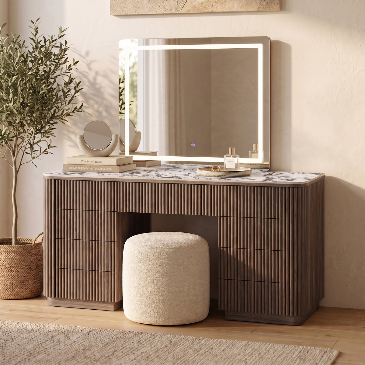 Walnut vanity table with ribbed storage drawers, marble-look top, and LED-lit mirror with cream boucle stool