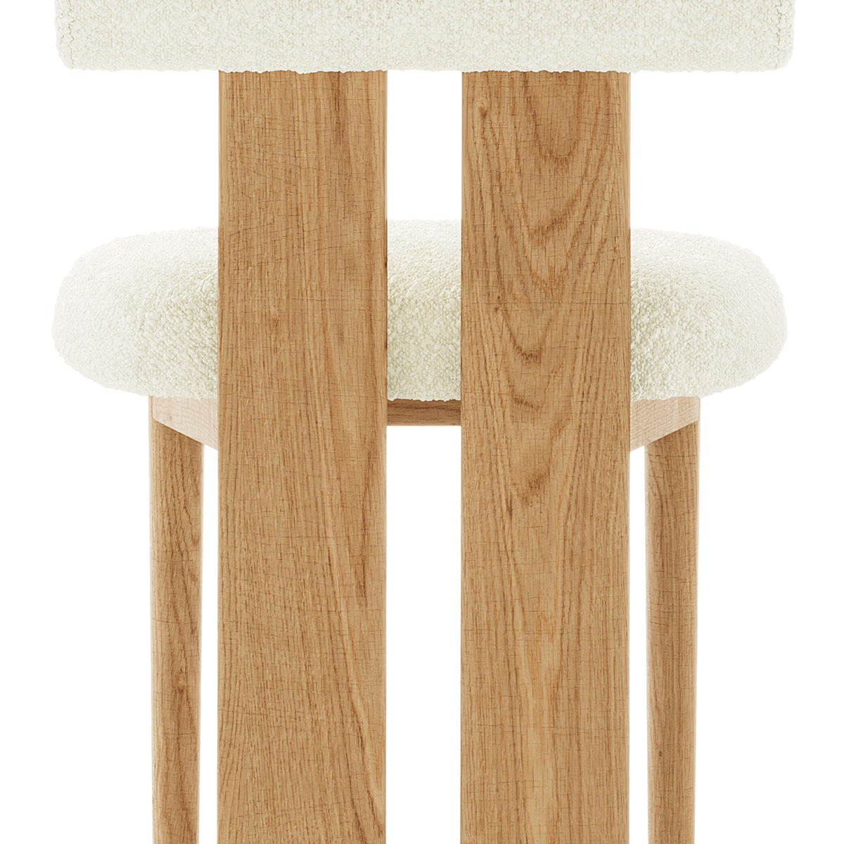 Wylie Boucle Oak Dining Chair Set features a close-up of the plush boucle fabric seat and backrest, solid oak frame, and oak-paneled legs, showcasing its elegant and sturdy design.