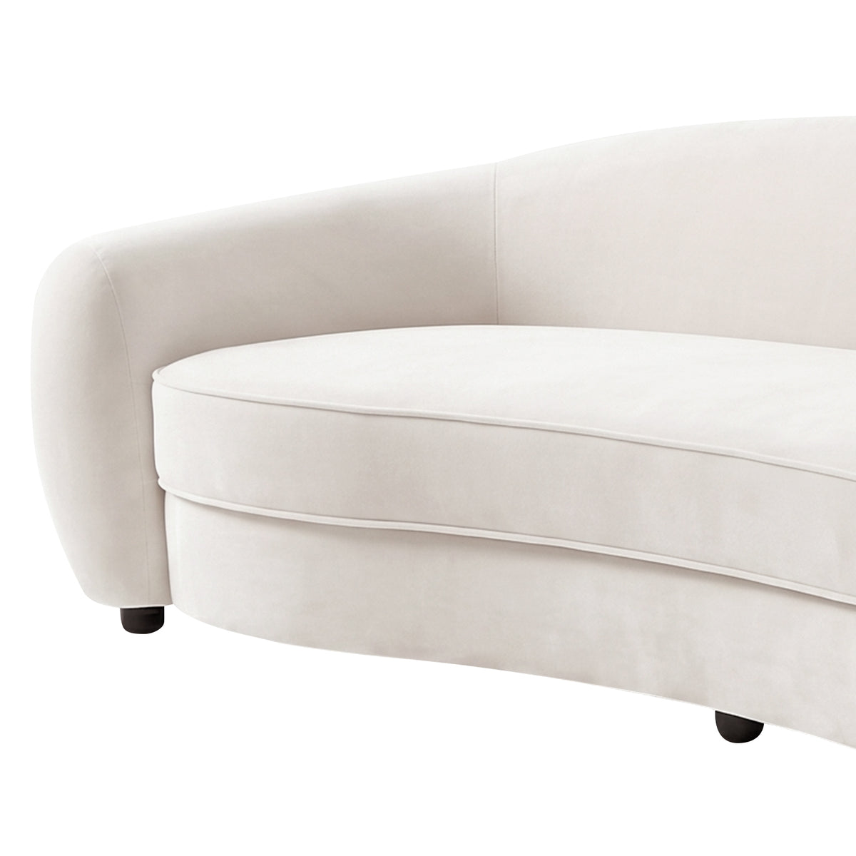 Close-up of curved cream white velvet sofa with rounded armrest, upholstered seat cushion, and black legs on white background