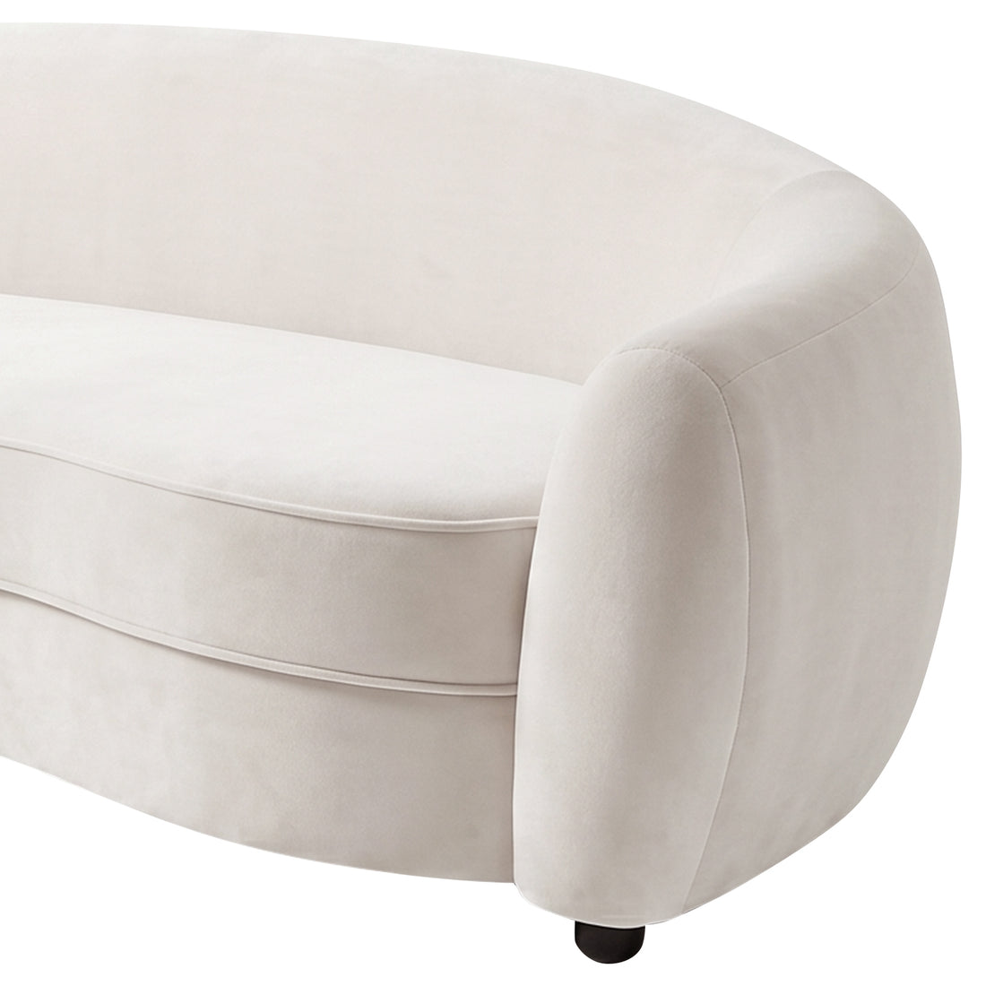 Close-up of curved cream white velvet sofa armrest and cushion detail on white background