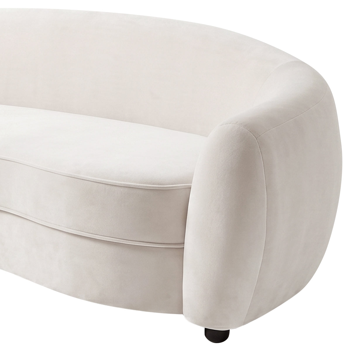Close-up of curved cream white velvet sofa armrest and cushion detail on white background