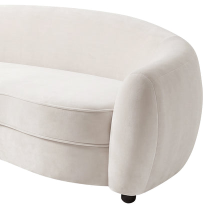 Close-up of curved cream white velvet sofa armrest and cushion detail on white background