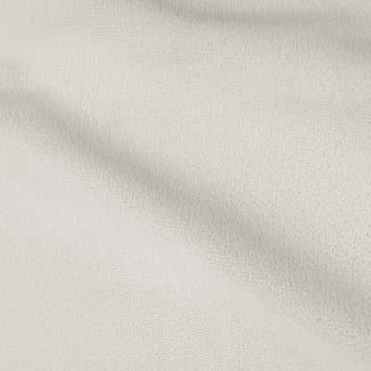 Close-up of cream white velvet upholstery showing soft texture and subtle sheen