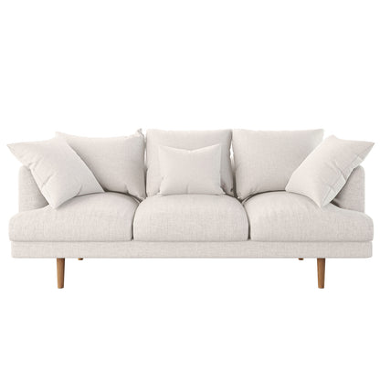 Colton 5-Seater Fabric Sofa in Cream White features a modern three-seat design with light upholstery, slender wooden legs, and five matching cushions, creating a relaxed, inviting look.