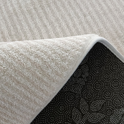 Corner of Modern Abstract Floor Rug with non-slip backing, showcasing plush microfiber pile. Complements the Colton 2-Seater Sofa in Cream White Fabric, enhancing contemporary living spaces with style and comfort.