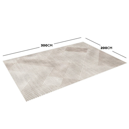 Colton 2 Seater Fabric Sofa with Rug - Cream White features a cream and beige geometric-patterned rug underneath, showcasing a modern, patchwork design. The sofa's contemporary style complements the rug beautifully.
