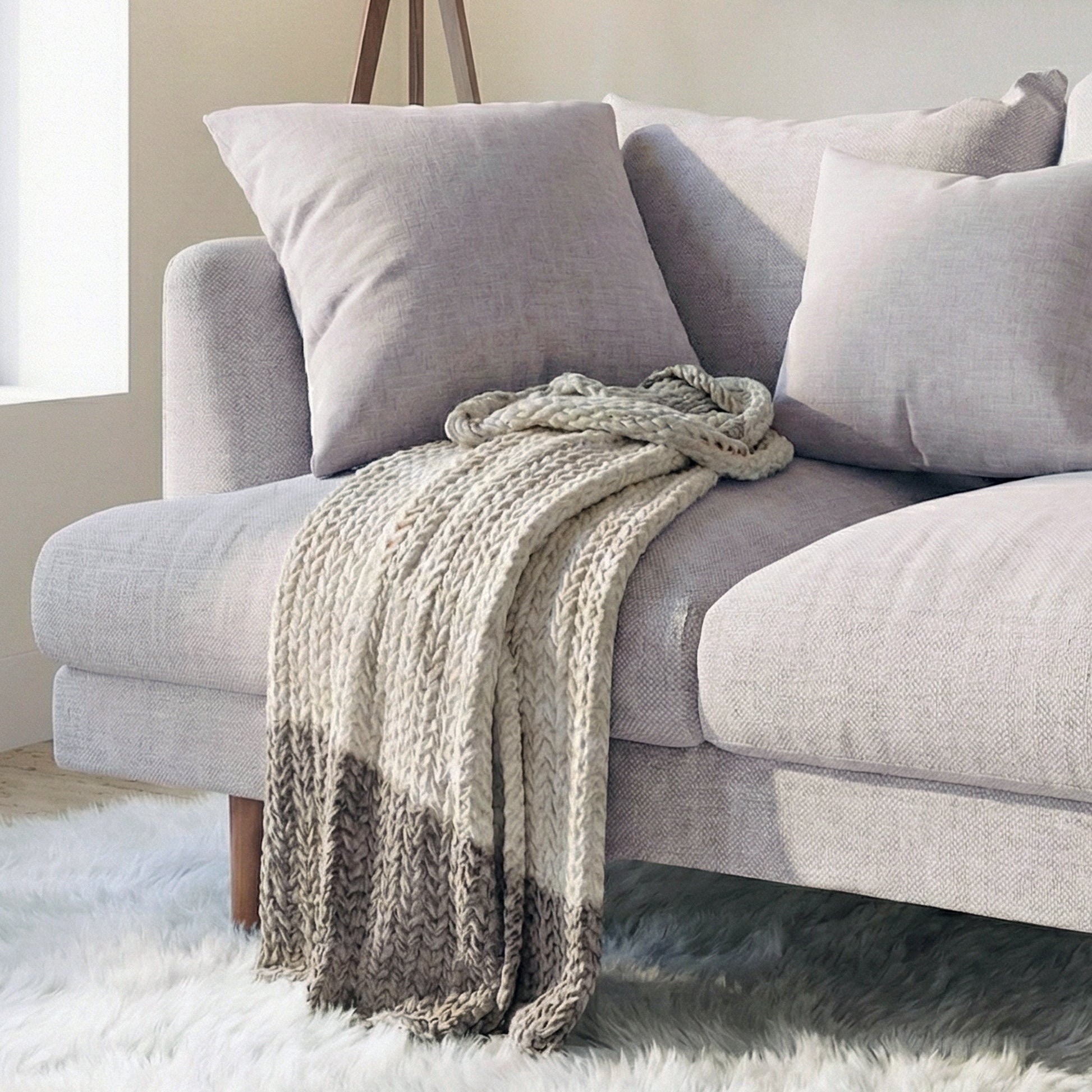 Colton 2-Seater Fabric Sofa in Stone with plush cushions, solid wood legs, and a chunky knit throw