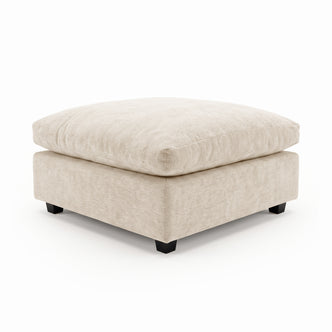 Beige upholstered ottoman with plush cushion on a white background