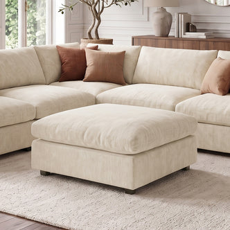 Light beige sectional sofa with ottoman styled in a living room