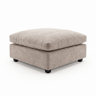 Light beige plush square ottoman on a white background.