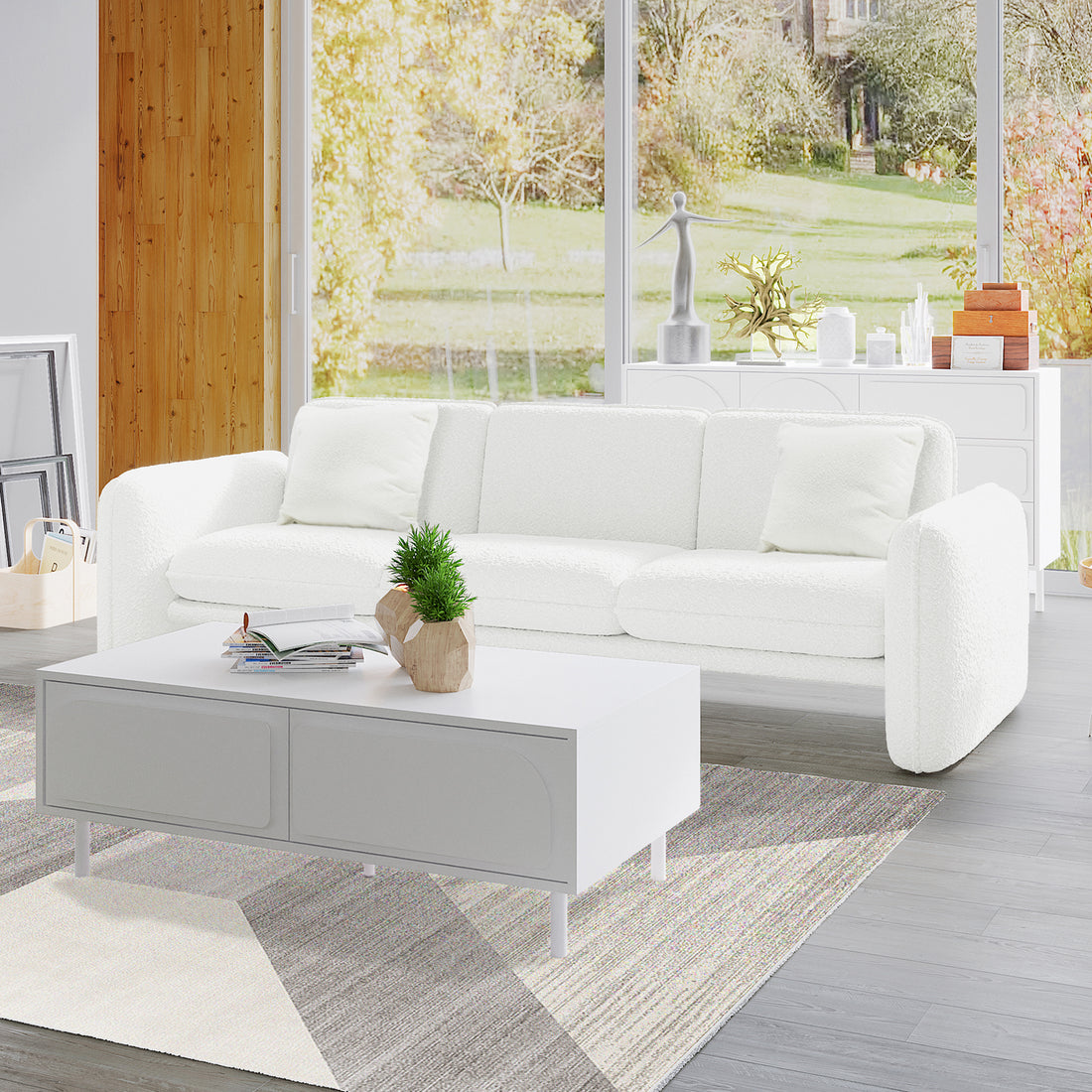 Ivano 4 Seater Boucle Upholstered Sofa in cream white with rounded armrests, shown in a bright living room with large windows