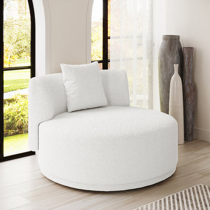 Lyana Single Seater Bouclé Sofa in Cream White, a round, plush lounge chair with matching pillow, set on light wood flooring alongside tall windows and decorative vases, exuding minimalist elegance.