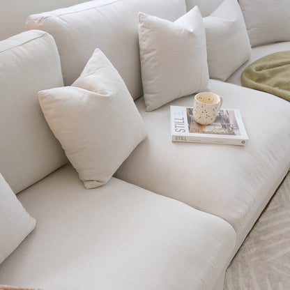 Millie 4-Seater Fabric Corner Chaise Sofa in Light Grey, showcasing plush cushions and a sleek design, ideal for modern living spaces. Features a robust frame and expansive seating for comfort.