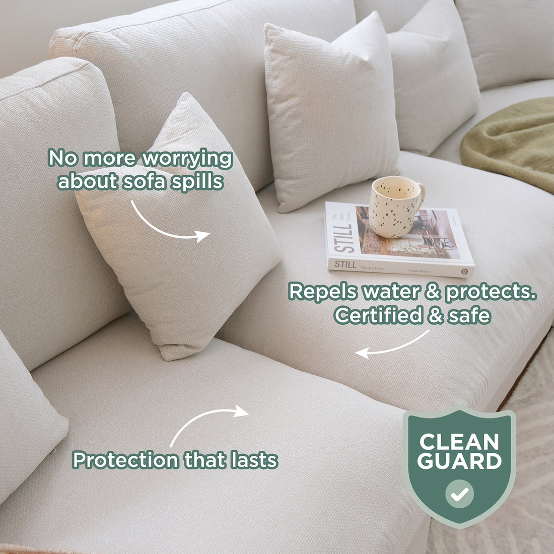Millie Fabric Ottoman Modular Sofa in light beige, featuring three throw pillows, an open book titled STILL, and a cream mug; highlighted benefits include spill protection and durability with a CLEAN GUARD certification.