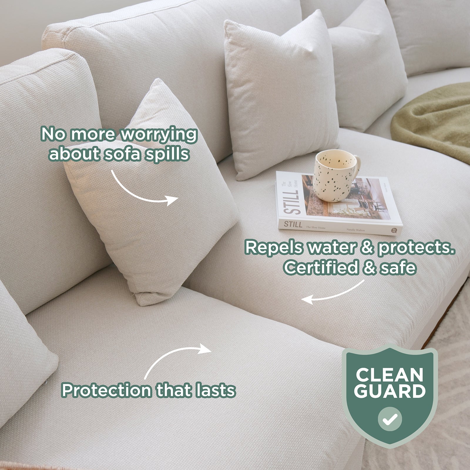 Millie Fabric Ottoman Modular Sofa in light beige, featuring three throw pillows, an open book titled STILL, and a cream mug; highlighted benefits include spill protection and durability with a CLEAN GUARD certification.