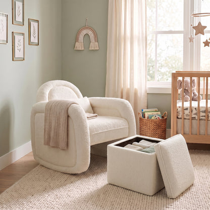 Cream white bouclé rocking chair with curved backrest and matching storage ottoman in nursery setting