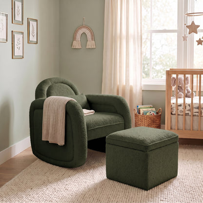 Dark forest green bouclé rocking chair with matching storage ottoman in nursery setting