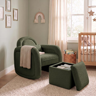 Dark forest green bouclé rocking chair with matching storage ottoman in nursery setting