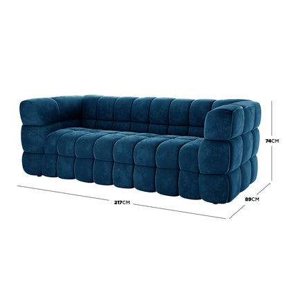 Norah 3 Seater Velvet Sofa in Blue, featuring oversized, cube-shaped tufts and plush upholstery, measuring 217 cm wide, 89 cm deep, and 74 cm tall, offers a modern, quilted design.