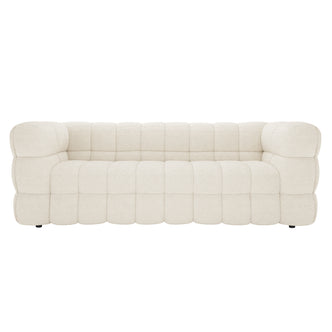 Norah 3 Seater Boucle Sofa in Cream White features a low-profile design with chunky, deeply tufted cushions. Its quilt-like bouclé upholstery enhances comfort and elegance, ideal for modern interiors.