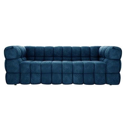 Norah 5 Seater Velvet Fabric Sofa Set in Blue featuring a modern design with deep-blue quilted upholstery, plush rounded cushions, and a low-profile, softly curved three-seater configuration.