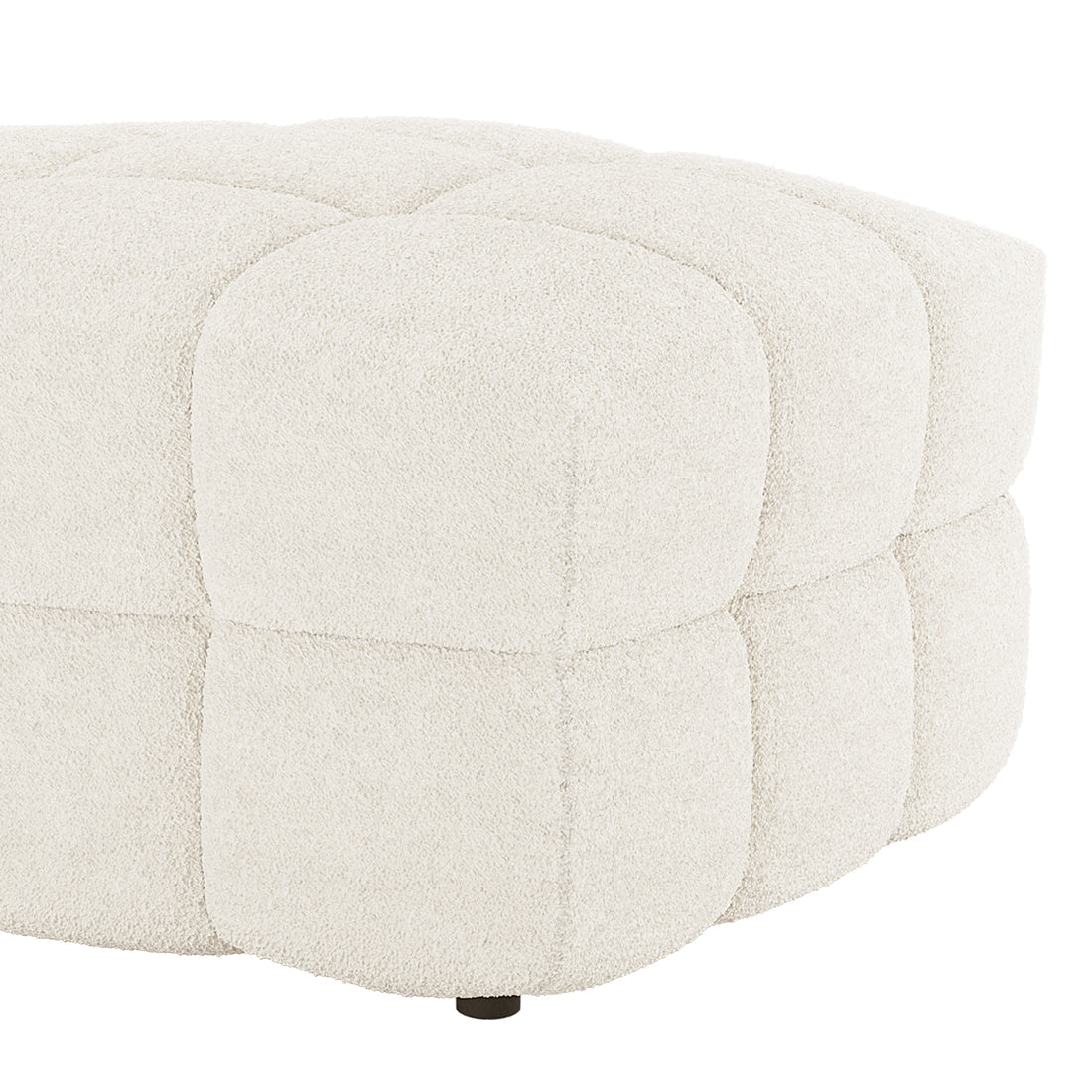 The Norah Boucle Ottoman in Cream White features a low, round design with quilted square panels in bouclé fabric, showcasing a small, dark foot at the base.