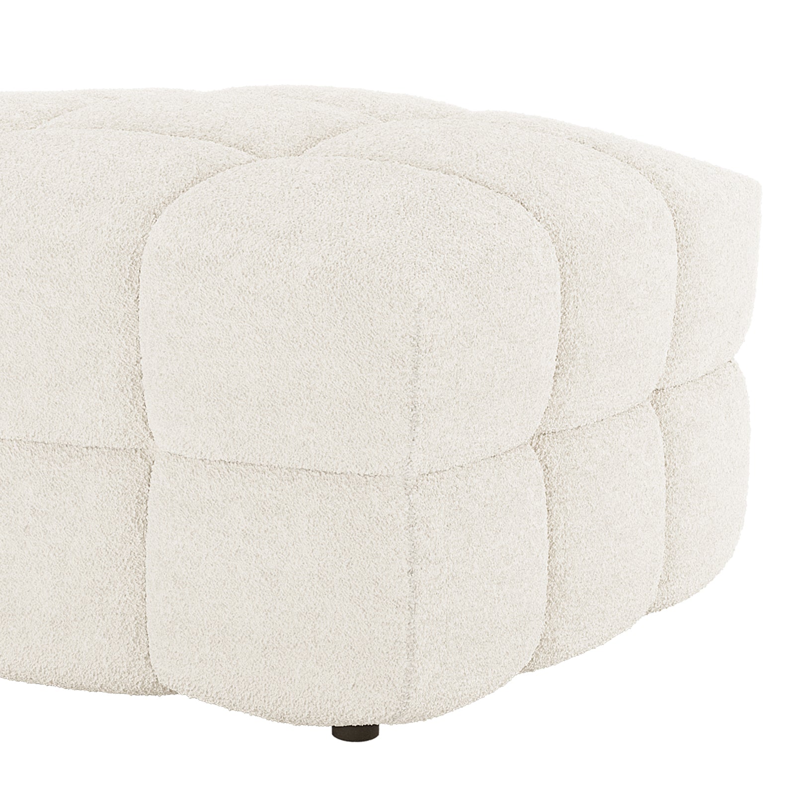 The Norah Boucle Ottoman in Cream White features a low, round design with quilted square panels in bouclé fabric, showcasing a small, dark foot at the base.