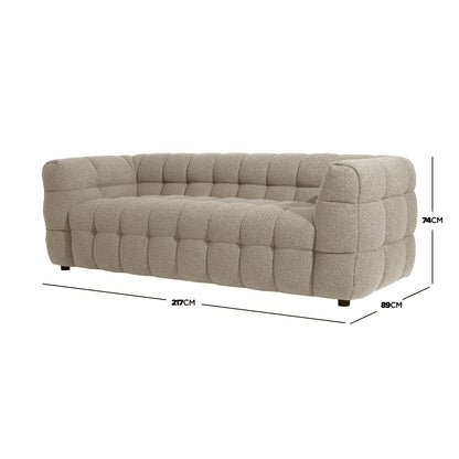 Norah 5 Seater Boucle Sofa Set with Ottoman in Warm Beige, featuring a tufted, quilted appearance on a light beige, low-profile three-seat sofa, showcasing plush cushions and short, dark feet.