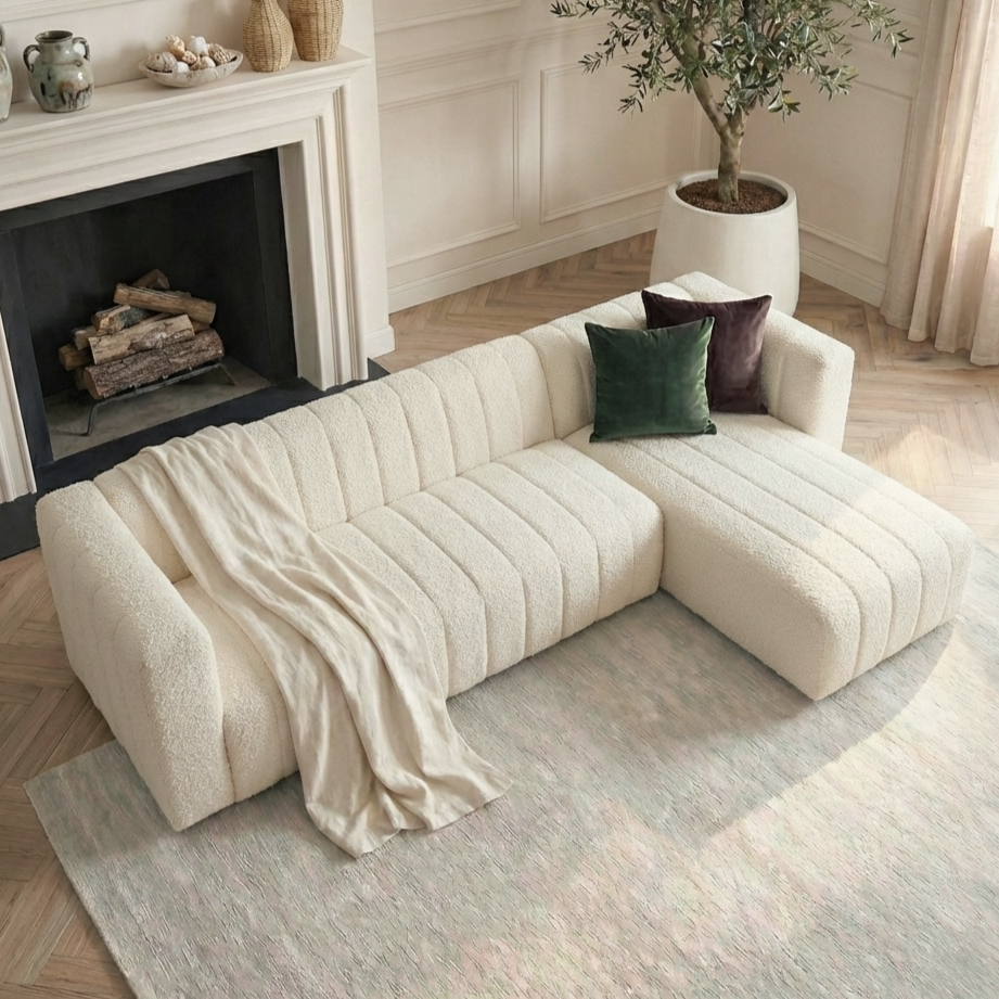 Cream boucle chaise sofa with green cushions in elegant living room
