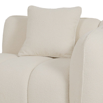 Close-up of cream boucle sofa with rounded cushions and matching throw pillow, showing textured fabric detail