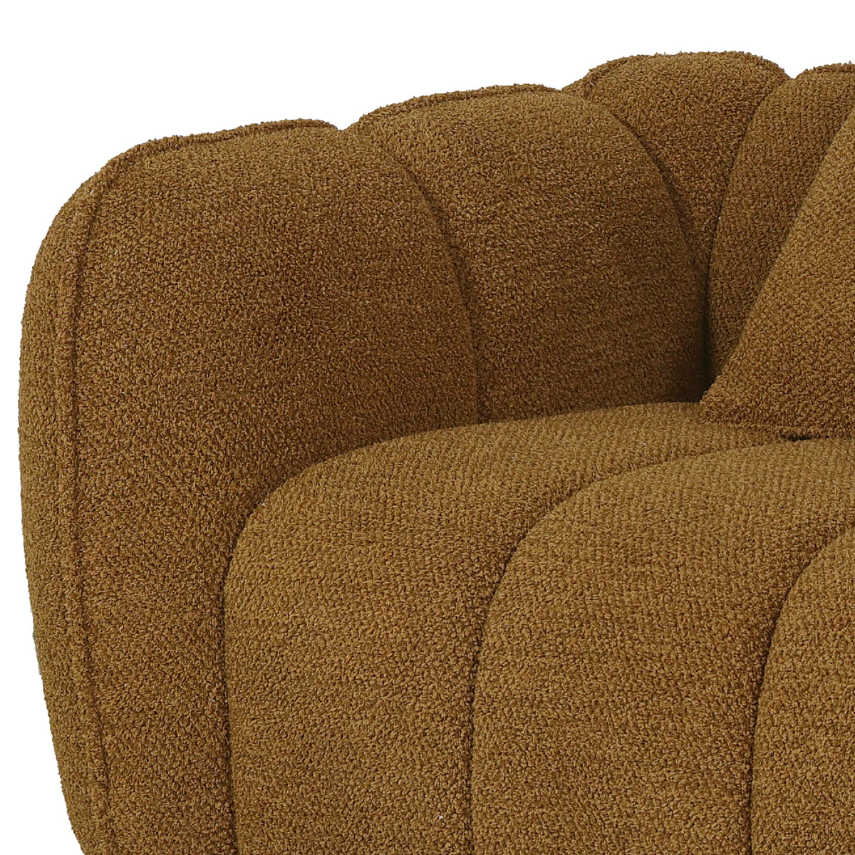 Close-up of mustard brown boucle fabric upholstery with channel tufting detail on sofa