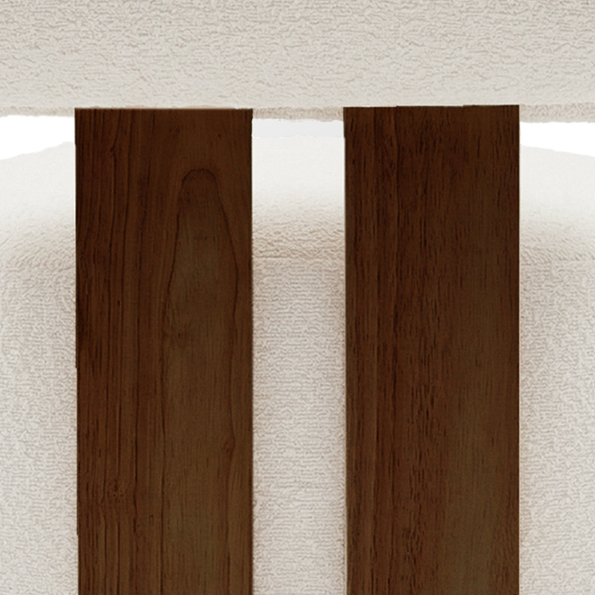 Close-up of the Renley Boucle Armless Accent Chair in Cream White, showcasing dark-stained wooden slats against a white upholstered backdrop, highlighting its elegant design and modern organic lines.