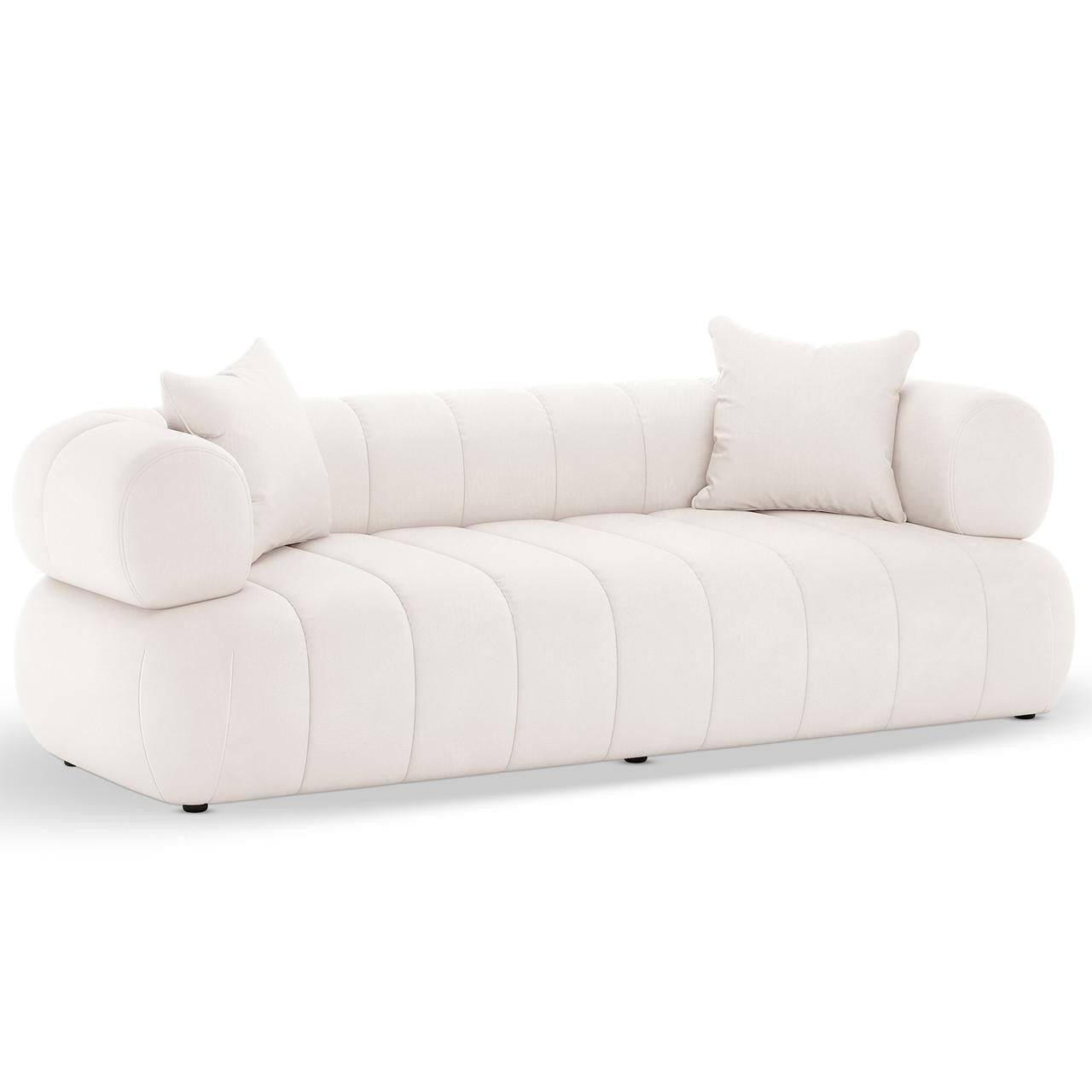 Samira 3 Seater Velvet Sofa in Cream features a modern design with vertical channel tufting, cylindrical bolsters, and matching throw pillows, offering plush comfort and elegance on a durable frame.