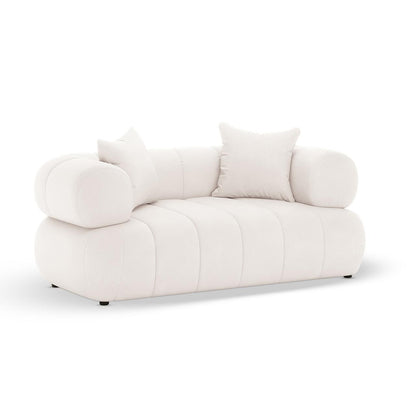 Samira 5 Seater Velvet Sofa Set in Cream features an off-white upholstered design with tubular armrests, channel-stitched seat, and two loose square pillows, offering modern elegance and comfort.