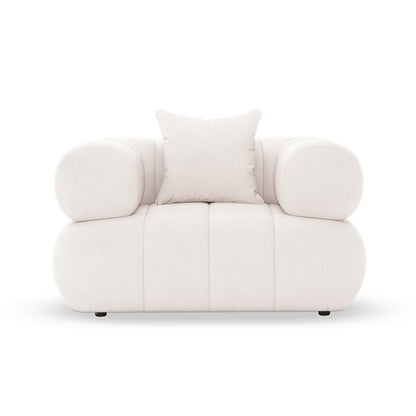 Samira Single Seater Velvet Sofa Cream, featuring plush velvet upholstery and a single pillow, elegantly perched on a couch with sturdy armrests, showcasing luxurious comfort and sophistication in design.