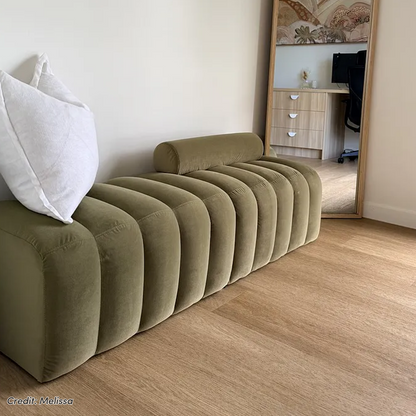 Sasa Velvet Bench with Backrest in Sage, featuring rounded tubular cushions and a cylindrical bolster pillow, shown on timber