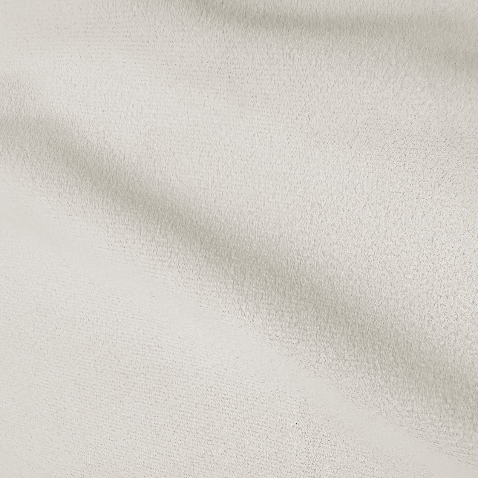 Close-up of cream white velvet upholstery showing soft texture and subtle shading