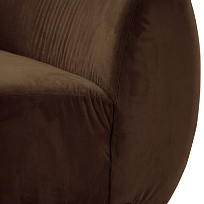 Close-up of curved velvet sofa in warm taupe brown showing seat cushion and backrest detail