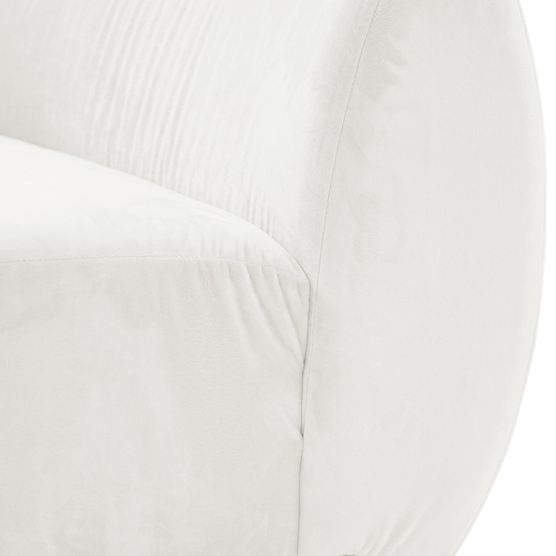 Close-up of cream white velvet sofa showing curved armrest and plush fabric texture