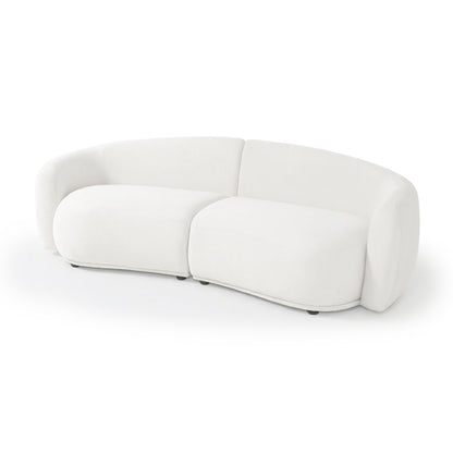 Modern curved white upholstered sofa on white background