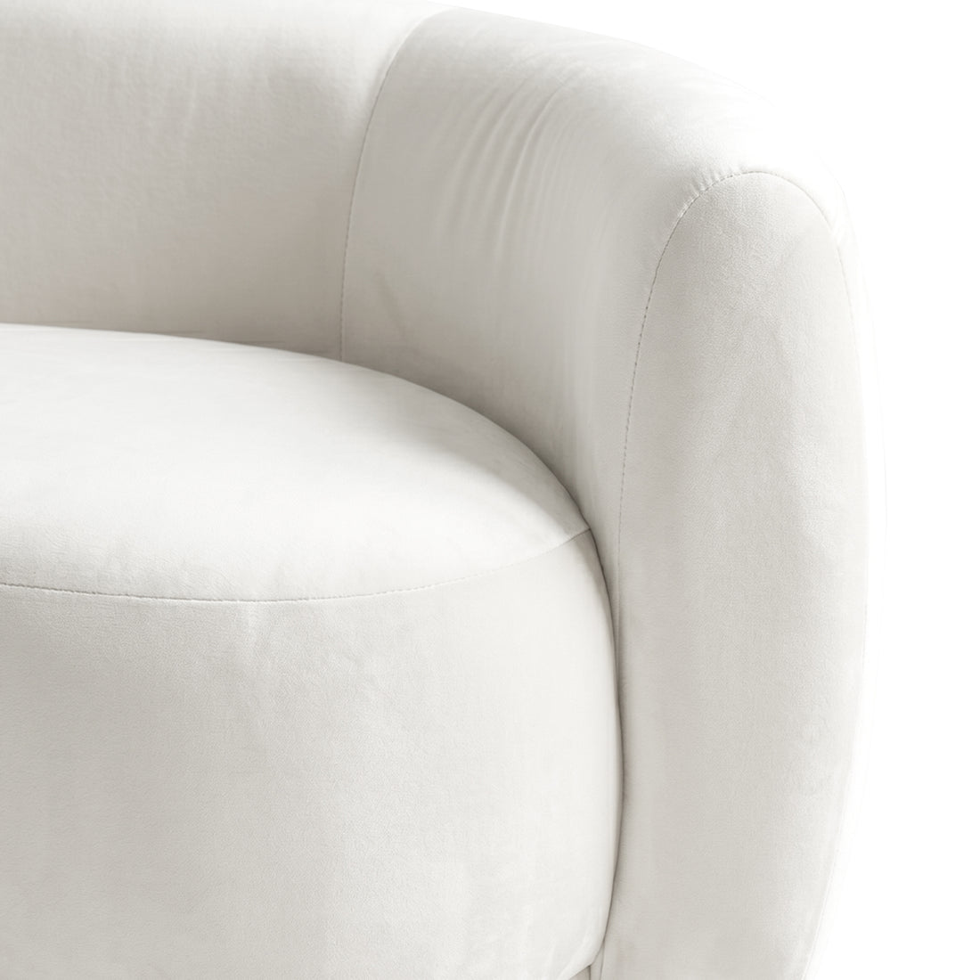 Close-up of curved cream white velvet sofa arm and cushion detail showing stitching