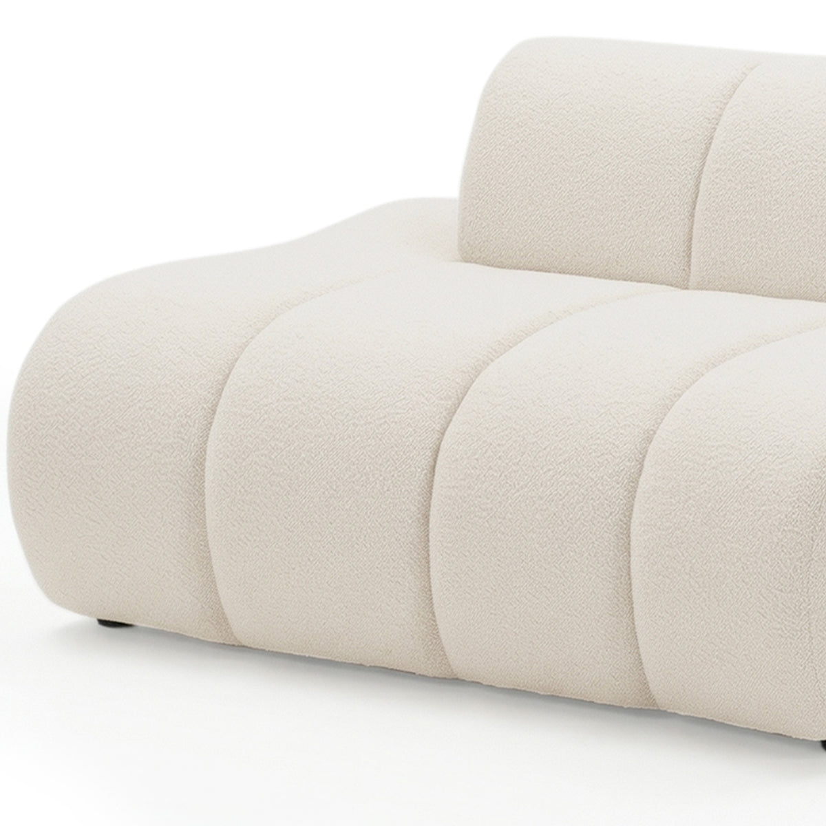 Close-up of curved modular sofa in cream white boucle fabric showing rounded seat cushions and backrest detail on white
